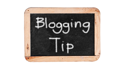 Small blackboard with a wooden frame with 'Blogging Tip' written in white chalk on it.